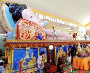 Volunteers clean the Sleeping Buddha statue