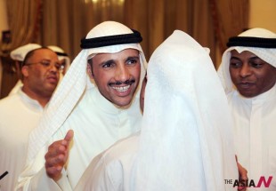 (130728) -- KUWAIT CITY, July 28, 2013 (Xinhua) -- Kuwaiti candidate Marzouq Al-Ghaim (L) greets supporters after his victory in the parliamentary election in Kuwait City early on July 28, 2013. (Xinhua/Noufal Ibrahim)