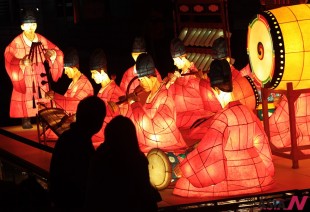 A couple looks at lanterns lit on the eve of Seoul Lantern Festival, which will be held from Nov. 1-17, along Cheonggye stream in Seoul, South Korea, Thursday, Oct. 31, 2013. (AP/NEWSis)