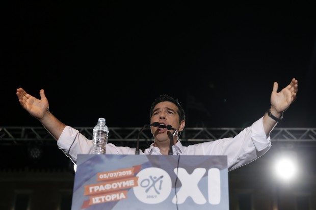 Greece's Prime Minister Alexis Tsipras delivers a speech during a rally organized by supporters of the no vote in Athens, Friday, July 3, 2015. A new opinion poll shows a dead heat in Greece's referendum campaign with just two days to go before Sunday's vote on whether Greeks should accept more austerity in return for bailout loans. The sign on the lectern reads, ''We are writing history, NO.'' (AP Photo)