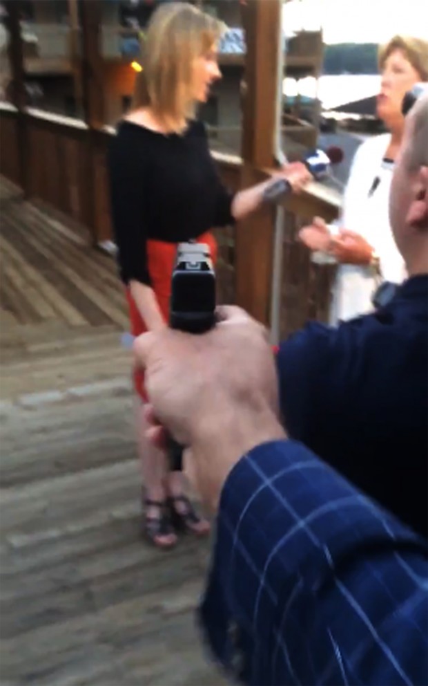 In this framegrab from video posted on Bryce Williams Twitter account and Facebook page, Williams, whose real name is Vester Lee Flanagan II, aims a gun over the shoulder of WDBJ-TV cameraman Adam Ward at reporter Alison Parker as she conducts a live on-air interview. Moments later, Flanagan fatally shot Parker and Ward and injured Vicki Gardner, who was being interviewed. The station said Flanagan was also an employee at WDBJ and appeared on air as Bryce Williams. (Vester Lee Flanagan II/Twitter via AP)