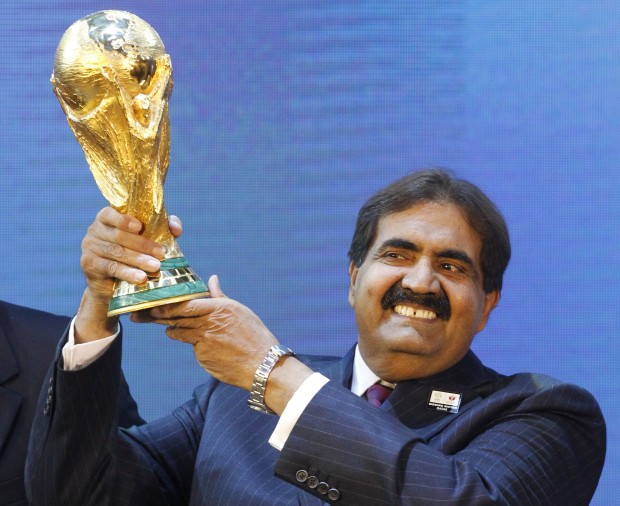 Sheikh Hamad bin Khalifa Al-Thani, Emir of Qatar, holds the World Cup trophy after the announcement of Qatar hosting the 2022 soccer World Cup in Zurich, Switzerland. (AP Photo/Anja Niedringhaus)