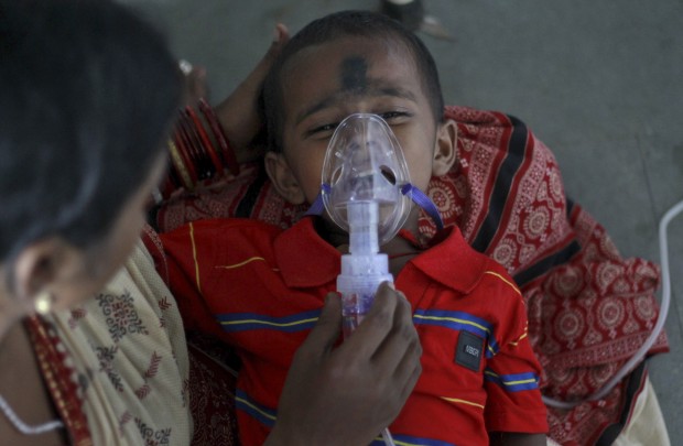 An Indian child cries as he is administered oxygen at Sishu Bhawan, a state run pediatrics hospital in Cuttack, Orissa state, India, Thursday, Aug.27, 2015. Representatives from 24 countries gathered in New Delhi Thursday for a two-day summit aimed at ending preventable child and maternal deaths. (AP Photo/Biswaranjan Rout)