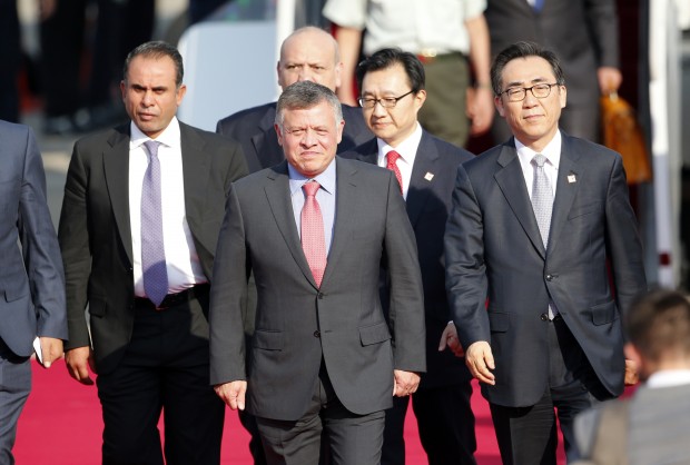 Jordan's King Abdullah II, center, is escorted by South Korean Foreign Affairs' 2nd Vice Minister Cho Tae-yul, right, upon his arrival at Seoul Airport in Seongnam, South Korea, Thursday, Sept. 10, 2015. King Abdullah II who is on a two-day visit will meet South Korean President Park Geun-hye. (AP Photo/Lee Jin-man) 