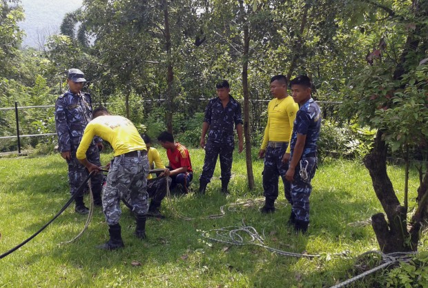 Nepalese police rescue team carry a search operation near a river side area at Nadipur, in Nepal, Thursday, Sept. 10, 2015. Police are searching a river in Nepal for the body of a 27-year-old teacher Dahlia Yehia from Texas who was beaten to death and thrown from a bridge in western Nepal last month. (AP Photo/Santosh Pokharel)