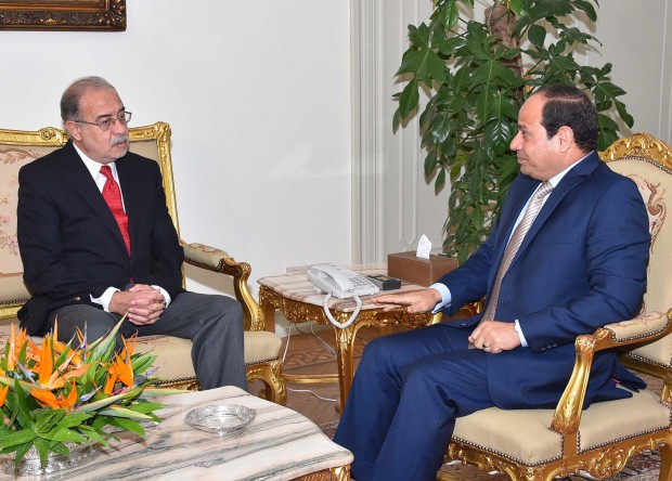 Egyptian President Abdel-Fattah el-Sissi, right, meets with Petroleum Minister Sheriff Ismail in Cairo, Egypt. Prime Minister Ibrahim Mehleb and his Cabinet resigned Saturday in the face of intense criticism from state-friendly media that reflects growing discontent but stops short of faulting el-Sissi, the former general who led the overthrow of an Islamist president two years ago. El-Sissi tasked Ismail with forming a new Cabinet within a week. (MENA via AP) 