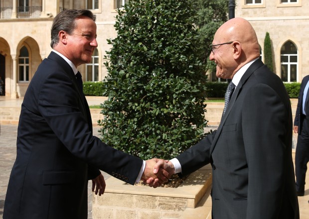 British Prime Minister David Cameron, left, shakes hands with his Lebanese counterpart, Tammam Salam, on his arrival to the Lebanese Government House, in Beirut, Lebanon, Monday, Sept. 14, 2015. British Prime Minister David Cameron met Monday in Lebanon with Syrian refugees who will resettle in Britain and vowed to continue his country?s support to Lebanese troops fighting extremists of the Islamic State group. (AP Photo/Bilal Hussein, Pool)  