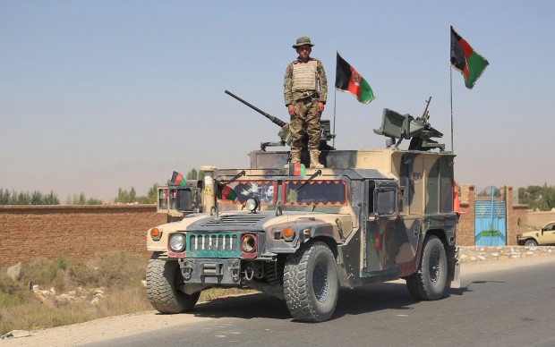 An Afghan soldier stands on a military vehicle outside a prison following an attack by Taliban militants in Ghazni province in eastern Afghanistan, Sept. 14, 2015. Some 352 inmates, including dozens of Taliban members, escaped at early hours of Monday after militants attacked a provincial prison in Afghanistan's eastern province of Ghazni, said an official. (Xinhua/Rahmat)