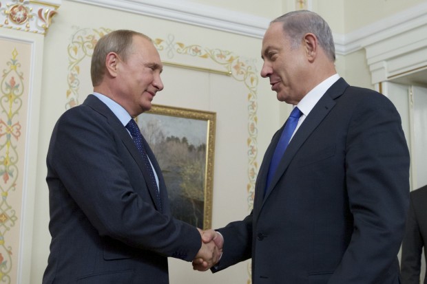 Russian President Vladimir Putin shakes hands with Israeli Prime Minister Benjamin Netanyahu, right, during their meeting in the Novo-Ogaryovo residence, outside Moscow, Russia. (AP Photo/Ivan Sekretarev, Pool) 