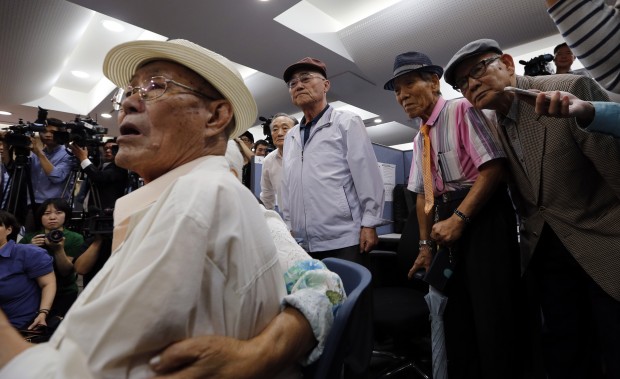 South Korean applicants for the family reunion, who were separated from their families during the Korean War, check their names on the candidates' lists during a computer based selection for the upcoming family reunions at the Korea Red Cross headquarters in Seoul, South Korea, Wednesday, Sept. 9, 2015. North and South Korea agreed Tuesday to hold reunions next month of families separated by the Korean War in the early 1950s, a small but important bit of progress for rivals that just last month were threatening each other with war. (AP Photo/Lee Jin-man) 