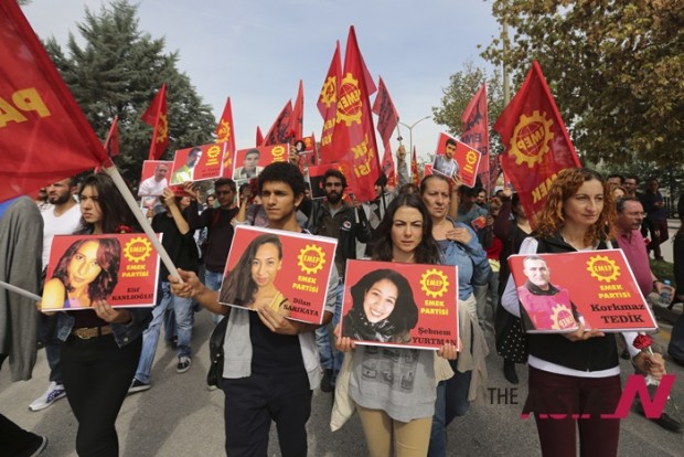 Protesters carrying pictures of people killed in Saturday's bombing attacks, walk during a march in Ankara, Turkey, Sunday, Oct. 11, 2015. Turkey declared three days of mourning following Saturday's nearly simultaneous explosions that targeted a peace rally in Ankara to call for increased democracy and an end to the renewed fighting between the Turkish security forces and Kurdish rebels. (AP Photo/Burhan Ozbilici)