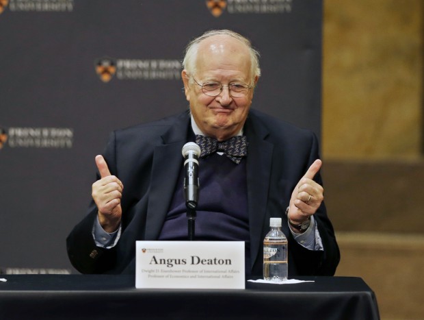 Angus Deaton gestures at a gathering at Princeton University after it was announced that he won the Nobel prize in economics for improving understanding of poverty and how people in poor countries respond to changes in economic policy Monday, Oct. 12, 2015, in Princeton, N.J. Deaton, 69, won the 8 million Swedish kronor (about $975,000) prize from the Royal Swedish Academy of Sciences for work that the award committee said has had "immense importance for human welfare, not least in poor countries." (AP Photo/Mel Evans) 