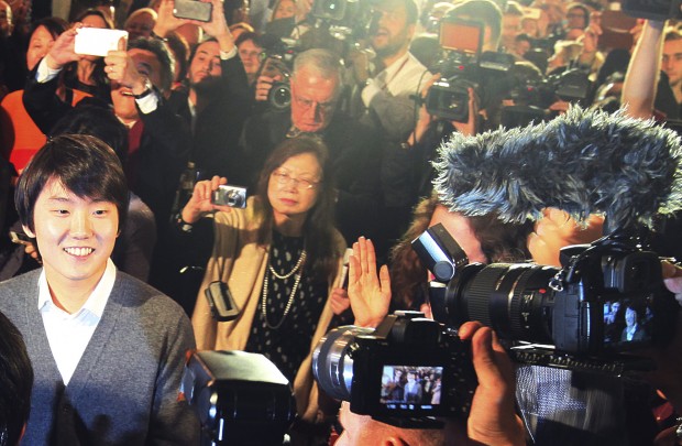 South Korean pianist Seong-Jin Cho, left, reacts after being named the winner of the 17th International Frederic Chopin Piano Competition in Warsaw, Poland, Tuesday, Oct. 20, 2015. (AP Photo/Czarek Sokolowski) 