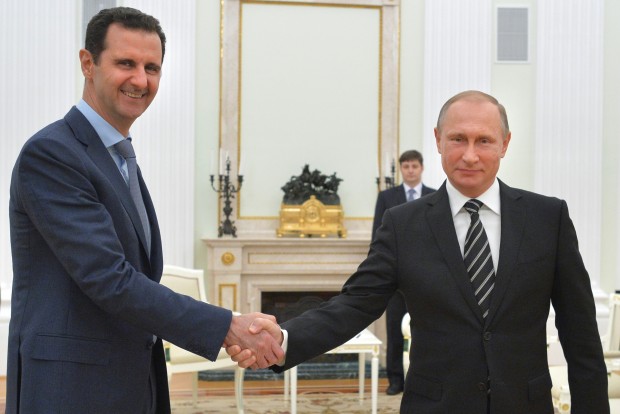 Russian President Vladimir Putin, right, shakes hand with Syria President Bashar Assad in the Kremlin in Moscow, Russia. Assad has traveled to Moscow in his first known trip abroad since the war broke out in Syria in 2011 to meet his strongest ally Russian leader Vladimir Putin, Syrian and Russian media reported Wednesday. (Alexei Druzhinin, RIA-Novosti, Kremlin Pool Photo via AP) 