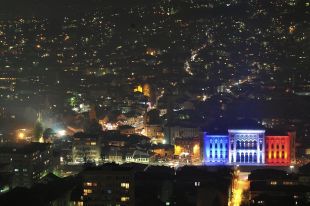 Sarajevo city hall is seen illuminated in the colors of French national flag in solidarity with France after the deadly attacks in Paris, in Sarajevo, Bosnia, Monday, Nov. 16, 2015. Multiple terrorist attacks across Paris on Friday night have left more than one hundred dead and many more injured. (AP Photo/Amel Emric)