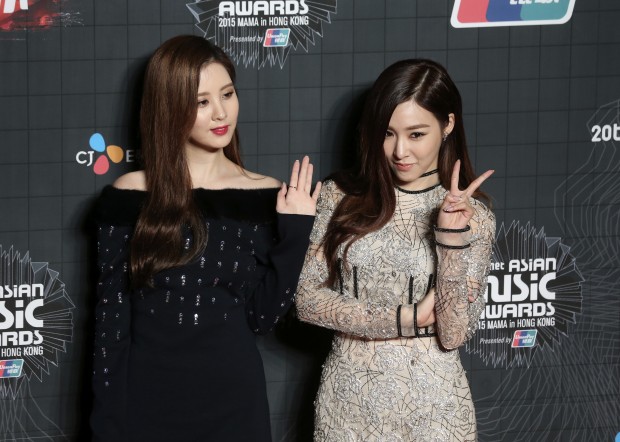 South Korean singer Seohyun, left, and Tiffany from the female group Girls' Generation, pose for the photographers on the red carpet of the 2015 Mnet Asian Music Awards (MAMA) in Hong Kong, Wednesday, Dec. 2, 2015. (AP Photo/Kin Cheung)