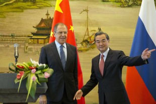 Chinese Foreign Minister Wang Yi, right gestures next to Russian Foreign Minister, Sergey Lavrov before they leave after a joint press conference held at the Chinese Foreign Ministry in Beijing, China, Friday, April 29, 2016. (AP Photo/Ng Han Guan)