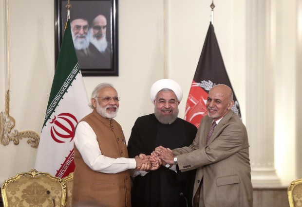 TEHRAN, May 24, 2016 (Xinhua) -- (From L to R) Indian Prime Minister Narendra Modi, Iranian President Hassan Rouhani and Afghan President Ashraf Ghani shake hands after their meeting at Saadabad Palace in Tehran, Iran, on May 23, 2016. Iran, India and Afghanistan signed a trilateral deal here on Monday to boost their regional trade and economic cooperation. The agreement, signed in the presence of Iranian President Hassan Rouhani, Indian Prime Minister Narendra Modi and Afghan President Ashraf Ghani, is to develop Iran's Chabahar port, which would serve as a transit route connecting the three countries. (Xinhua/Ahmad Halabisaz)