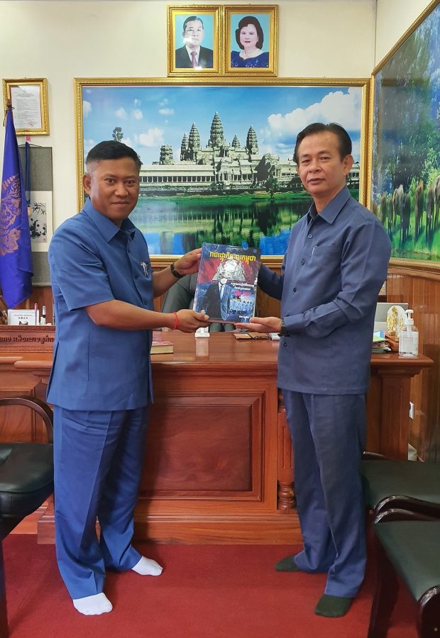 Sophal presenting a copy of his book (Facebook)