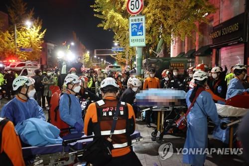 Rescuers move patients on Oct. 30, 2022, in Seoul's Itaewon district 