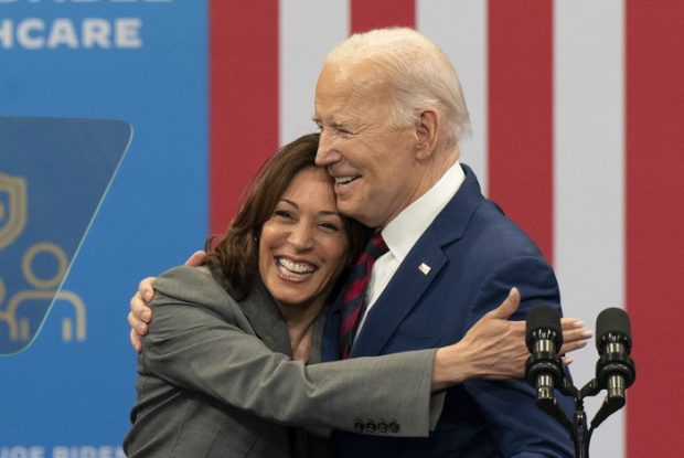 President Biden hugs Vice President Harris after dropping out of the race.